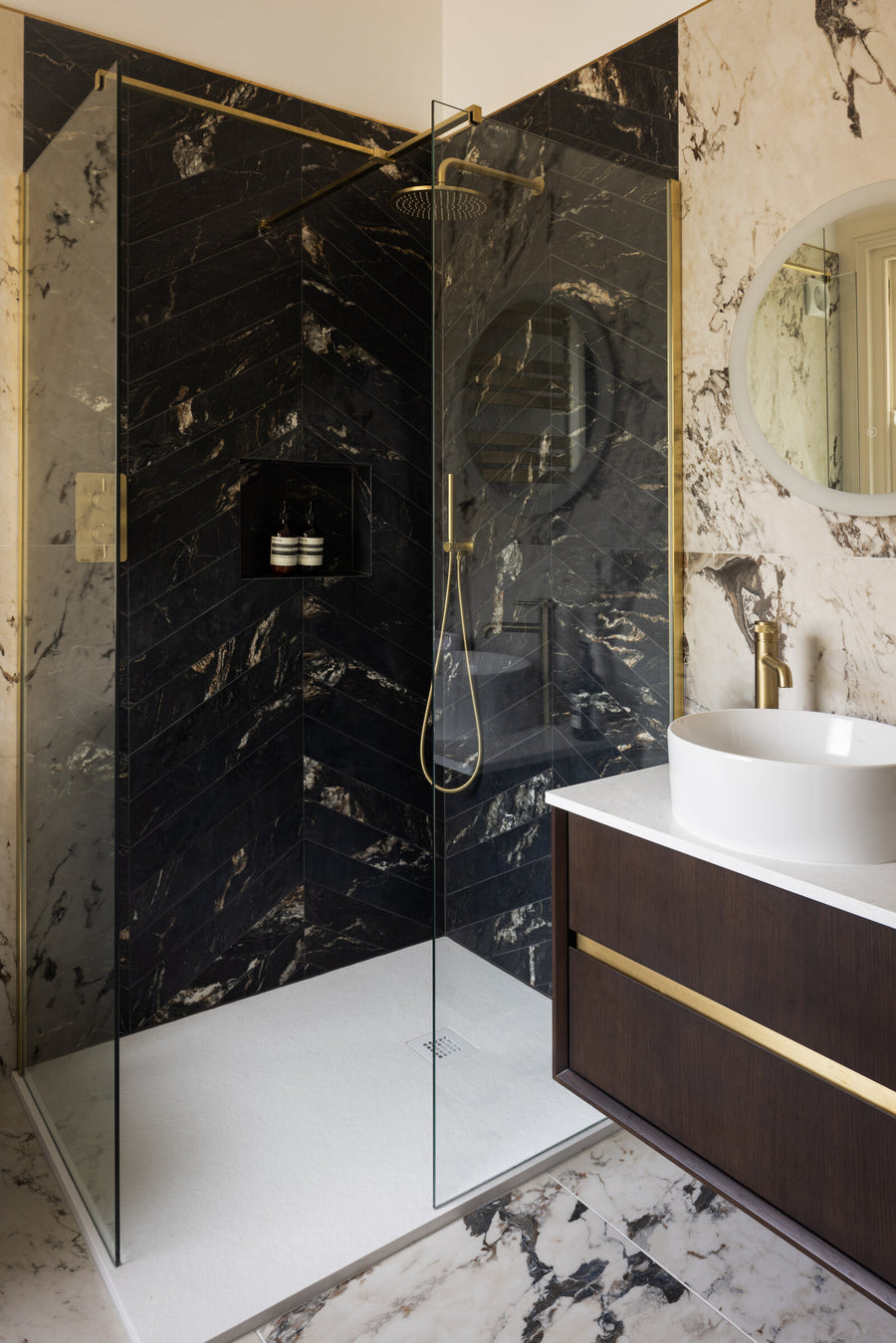 Ensuite with black and gold marble, a walk-in shower, brass fittings and a floating vanity with a vessel basin